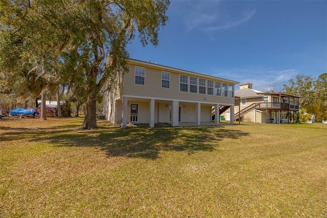 1056 Fiddler Trce, Townsend, GA 31331 - rear view of house with stairs and a yard