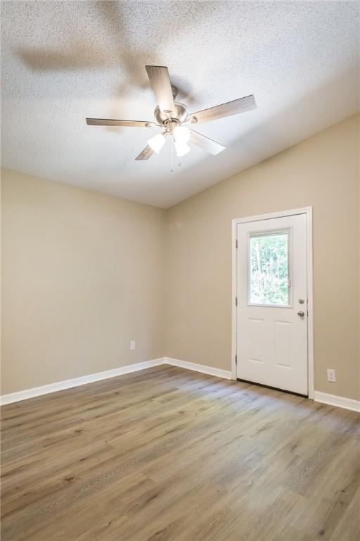 104 Bamboo Dr, Kingsland, GA 31548 - unfurnished room with wood finished floors, a ceiling fan, a textured ceiling, and lofted ceiling