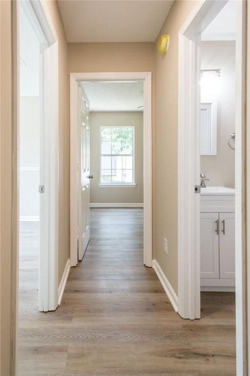 104 Bamboo Dr, Kingsland, GA 31548 - hall with light wood-style flooring and baseboards