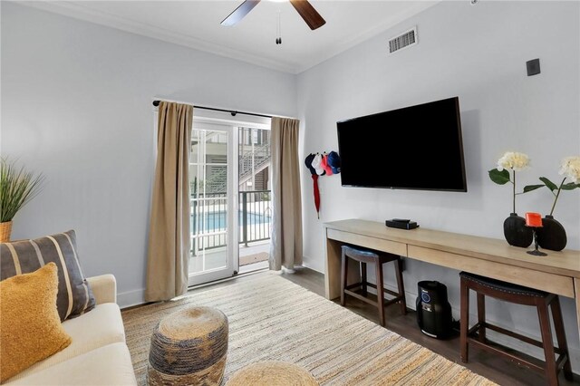 living room featuring ceiling fan and dark hardwood / wood-style floors