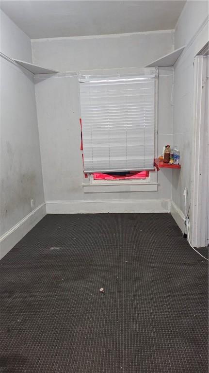 carpeted empty room with baseboards