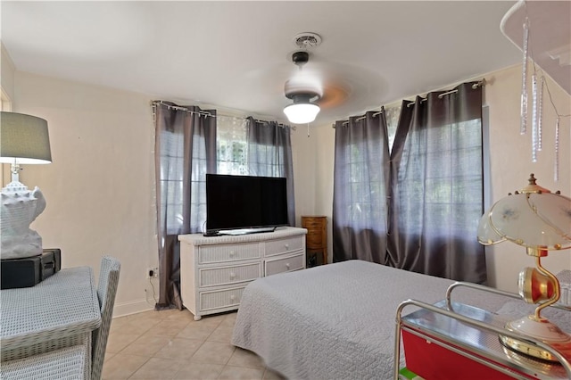 tiled bedroom featuring ceiling fan