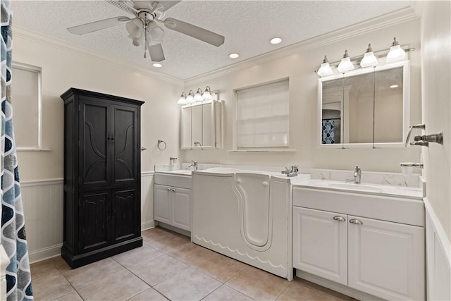 bathroom with tile patterned flooring, ceiling fan, ornamental molding, and a textured ceiling