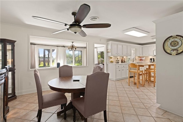 tiled dining room featuring ceiling fan with notable chandelier and crown molding