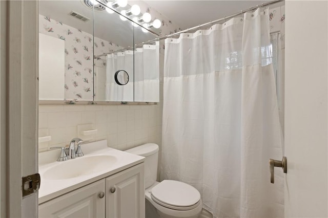 bathroom featuring vanity, a shower with shower curtain, decorative backsplash, toilet, and tile walls