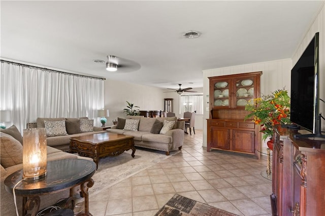 tiled living room with ceiling fan