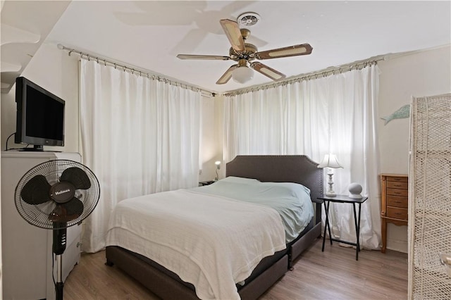 bedroom featuring hardwood / wood-style floors and ceiling fan