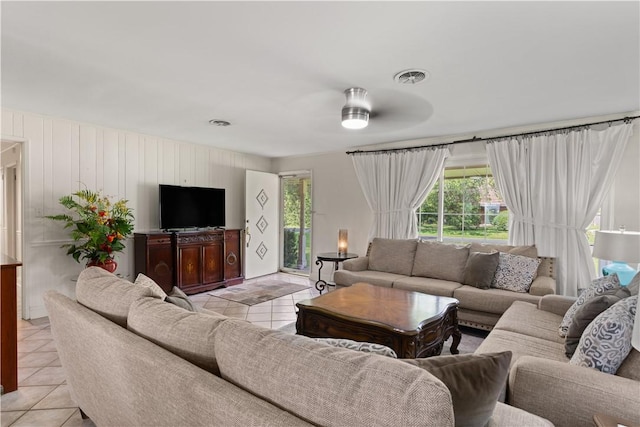 living room with ceiling fan and light tile patterned floors