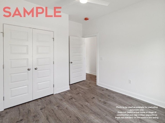 unfurnished bedroom with hardwood / wood-style floors, a closet, and ceiling fan