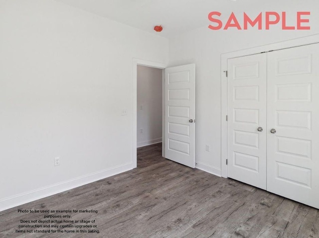 unfurnished bedroom featuring hardwood / wood-style flooring and a closet