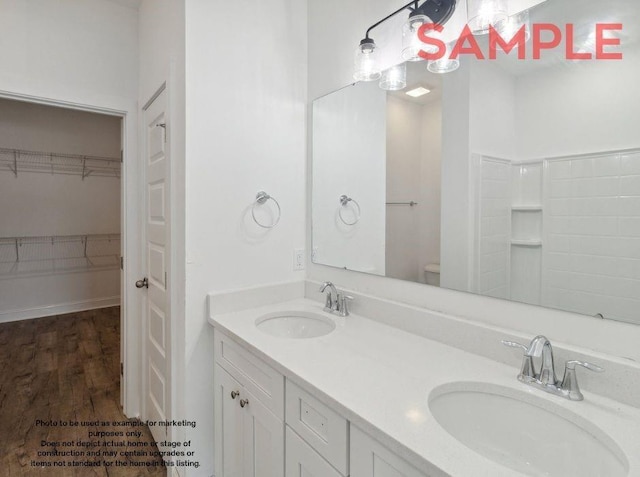 bathroom with vanity, toilet, and wood-type flooring