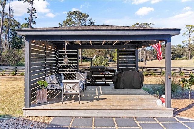 view of patio / terrace featuring a wooden deck and a grill