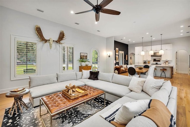 kitchen with white cabinets, light hardwood / wood-style flooring, stainless steel dishwasher, and sink