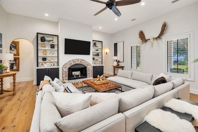 kitchen featuring pendant lighting, ceiling fan, appliances with stainless steel finishes, white cabinets, and a center island