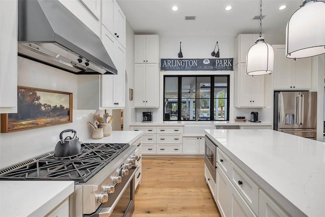 kitchen with sink, white cabinets, light hardwood / wood-style flooring, and dishwasher