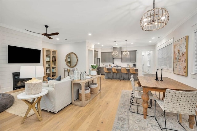 kitchen featuring a kitchen breakfast bar, light hardwood / wood-style flooring, high quality fridge, and a kitchen island with sink