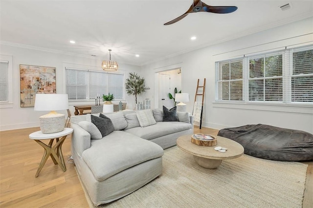 bedroom featuring hardwood / wood-style floors, ensuite bathroom, ceiling fan, and ornamental molding