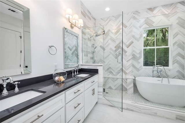 bathroom with vanity and independent shower and bath