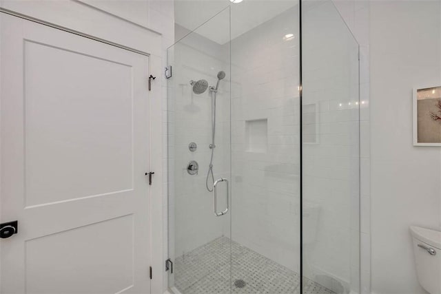 bathroom featuring toilet and walk in shower