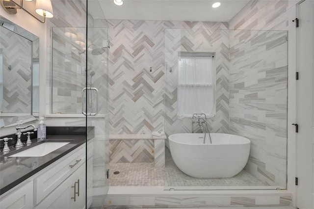 bathroom featuring vanity, independent shower and bath, and tile walls