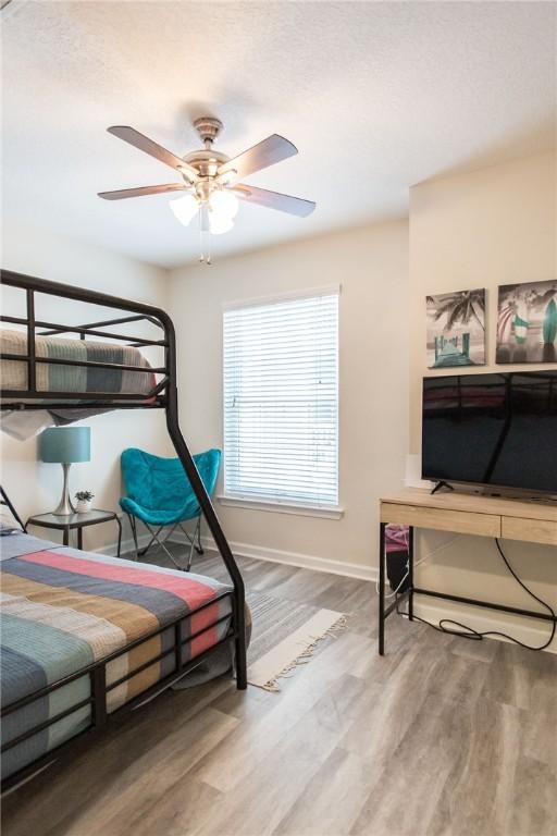200 Salt Air Dr Unit 139, Saint Simons Island, GA 31522 - bedroom featuring baseboards, wood finished floors, and a ceiling fan