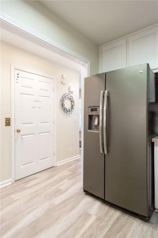 200 Salt Air Dr Unit 139, Saint Simons Island, GA 31522 - kitchen featuring stainless steel refrigerator with ice dispenser, light wood-type flooring, white cabinetry, and baseboards