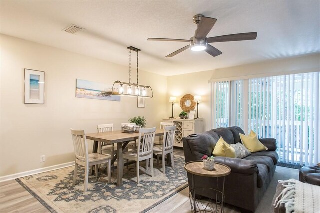 200 Salt Air Dr Unit 139, Saint Simons Island, GA 31522 - dining area with ceiling fan, baseboards, and light wood-style flooring