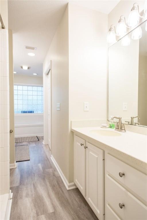 200 Salt Air Dr Unit 139, Saint Simons Island, GA 31522 - full bathroom featuring vanity, wood finished floors, and baseboards