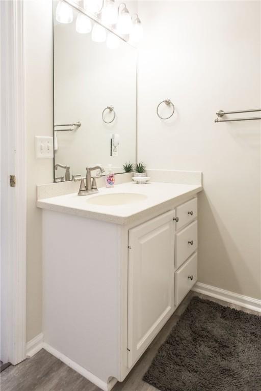 200 Salt Air Dr Unit 139, Saint Simons Island, GA 31522 - bathroom with vanity, baseboards, and wood finished floors