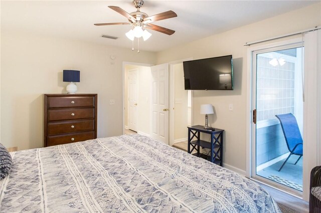 200 Salt Air Dr Unit 139, Saint Simons Island, GA 31522 - bedroom with access to exterior, a ceiling fan, and baseboards