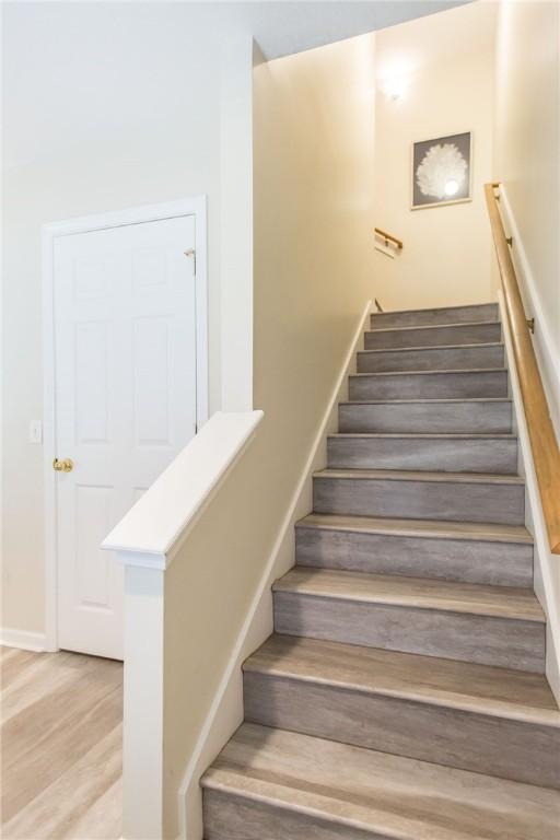 200 Salt Air Dr Unit 139, Saint Simons Island, GA 31522 - stairway featuring wood finished floors