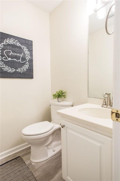 200 Salt Air Dr Unit 139, Saint Simons Island, GA 31522 - half bathroom featuring wood finished floors, toilet, and vanity