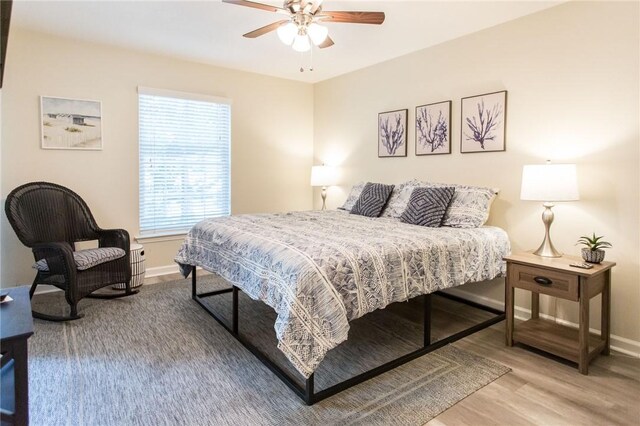 200 Salt Air Dr Unit 139, Saint Simons Island, GA 31522 - bedroom with wood finished floors, baseboards, and ceiling fan