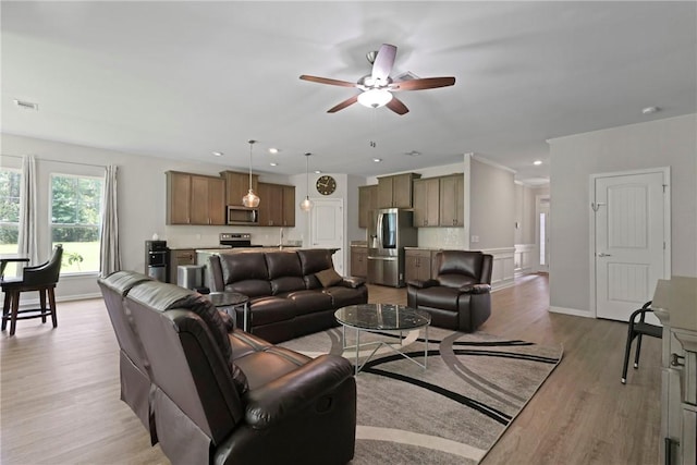 64 Wellington Cir, Brunswick, GA 31525 - living area with a ceiling fan, wood finished floors, and wainscoting