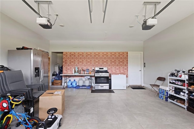 64 Wellington Cir, Brunswick, GA 31525 - garage with a garage door opener and stainless steel refrigerator with ice dispenser