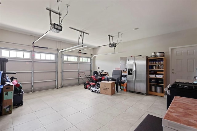 64 Wellington Cir, Brunswick, GA 31525 - garage featuring stainless steel fridge and a garage door opener