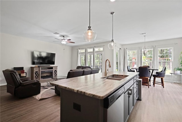 64 Wellington Cir, Brunswick, GA 31525 - kitchen featuring stainless steel dishwasher, plenty of natural light, and wood finished floors