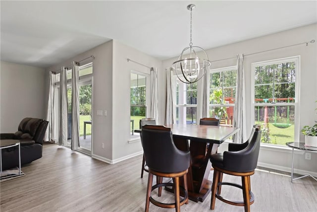64 Wellington Cir, Brunswick, GA 31525 - dining area featuring a chandelier, wood finished floors, and healthy amount of natural light