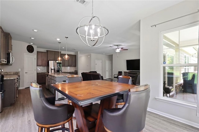 64 Wellington Cir, Brunswick, GA 31525 - dining room featuring a chandelier, ceiling fan, wood finished floors, and recessed lighting