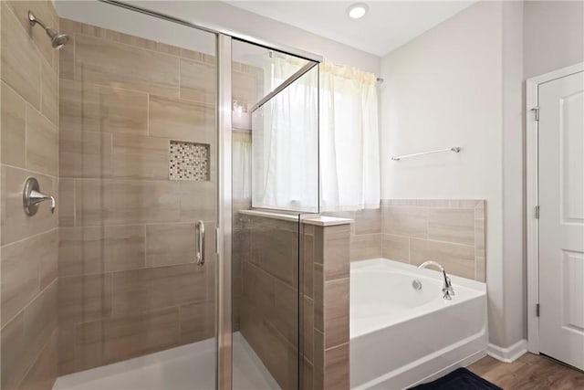 64 Wellington Cir, Brunswick, GA 31525 - full bathroom featuring a stall shower, a bath, and wood finished floors