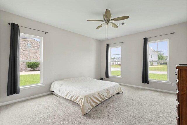 64 Wellington Cir, Brunswick, GA 31525 - carpeted bedroom featuring multiple windows and a ceiling fan