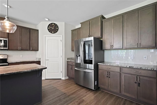 64 Wellington Cir, Brunswick, GA 31525 - kitchen with appliances with stainless steel finishes, dark wood-style flooring, light stone countertops, dark brown cabinetry, and backsplash