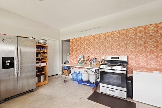 64 Wellington Cir, Brunswick, GA 31525 - kitchen featuring stainless steel appliances, light tile patterned floors, and light countertops