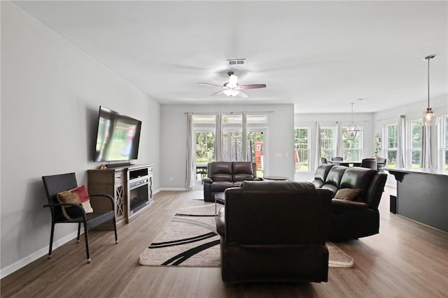 64 Wellington Cir, Brunswick, GA 31525 - living area with light wood-type flooring, a ceiling fan, and a chandelier