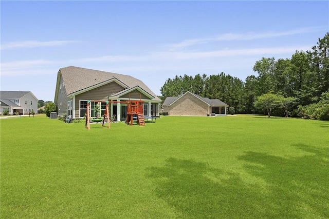 64 Wellington Cir, Brunswick, GA 31525 - rear view of property with a lawn and a playground