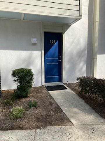 entrance to property featuring stucco siding
