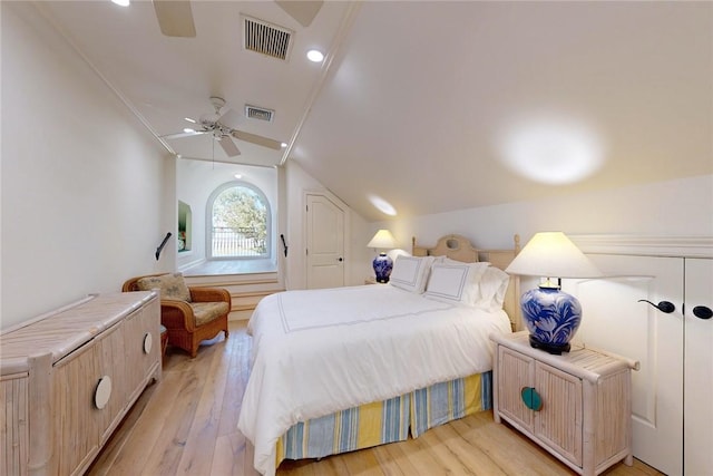 bedroom featuring lofted ceiling, light hardwood / wood-style floors, and ceiling fan