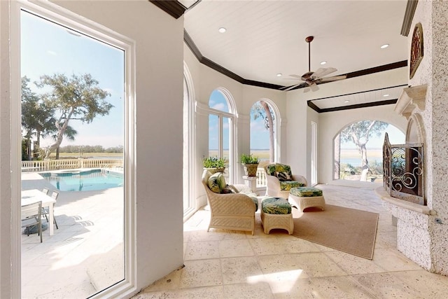 interior space with ceiling fan