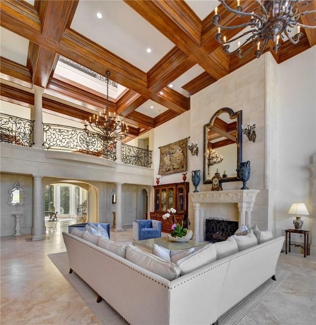 living room featuring a towering ceiling, beamed ceiling, coffered ceiling, crown molding, and an inviting chandelier