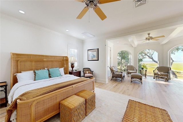 bedroom featuring ceiling fan, ornamental molding, and light wood-type flooring